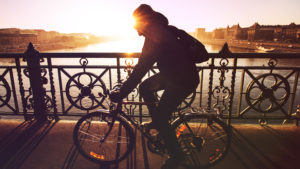 Man Riding Bike, European City, Bridge, River