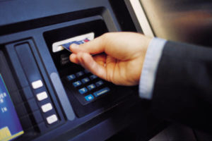 Man at ATM, Placing Debit Card Into Machine, Blue Color Context