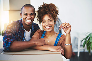 Shot of an attractive young couple moving house