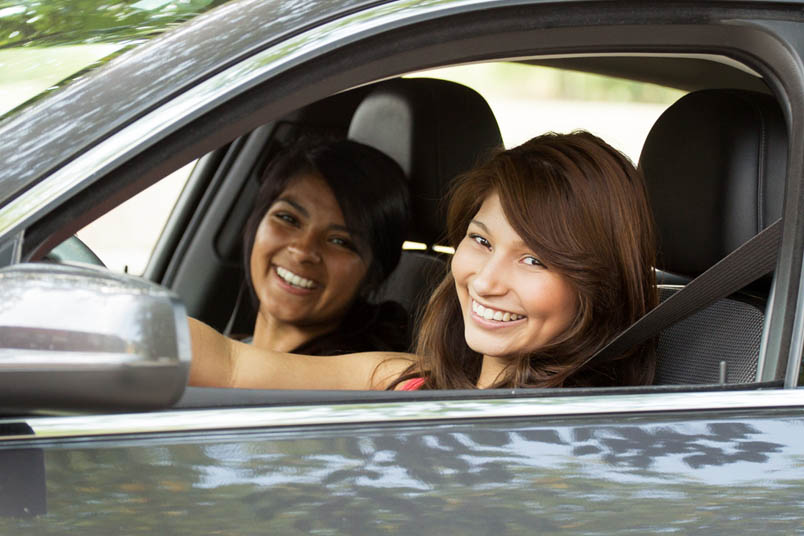 Woman sitting in car with friend