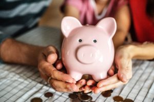 Hands holding piggy bank