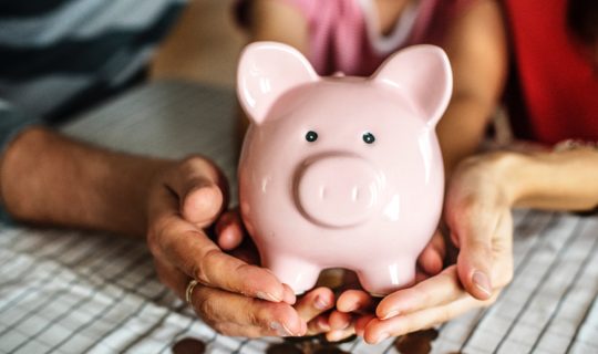 Hands holding piggy bank