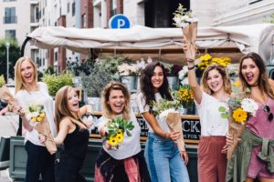 Group of women holding flowers