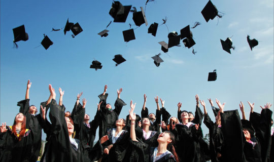 Group of students who have graduated and threw caps in the air