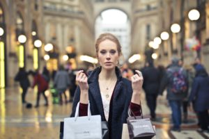 woman-wearing-black-coat-holding-assorted-color-shopping-bags