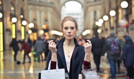 woman-wearing-black-coat-holding-assorted-color-shopping-bags