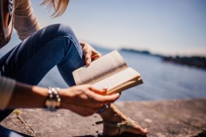 reading a book by the ocean