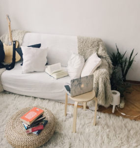 white couch with furry throw cover