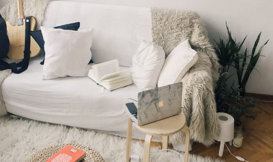 white couch with furry throw cover