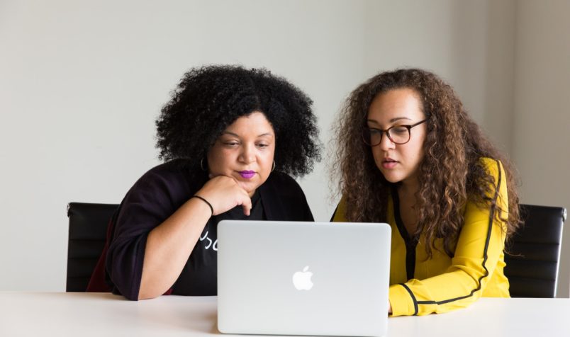 two ladies looking at computer screen