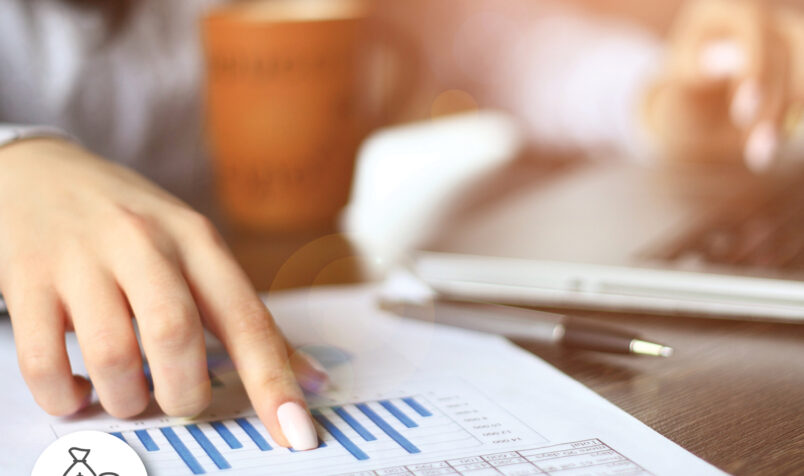 Person pointing, hand, cup, budgeting page, laptop